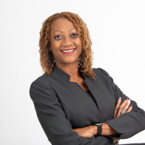 The image shows Dr. Stephanie S. Thomas, DHSc, MPA, the Secretary and a member of the board for 2023. She is smiling confidently with her arms crossed, wearing a dark gray blazer over a black top. Dr. Thomas has shoulder-length curly hair, and the white background highlights her professional and approachable demeanor.